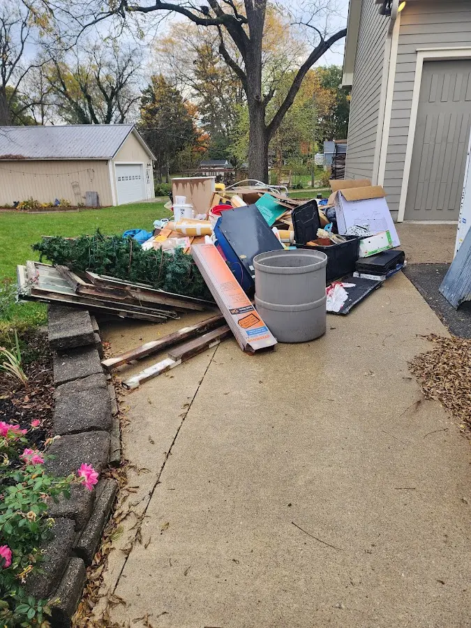 Dumpster being loaded with debris for Residential Dumpster Rental in Greenville